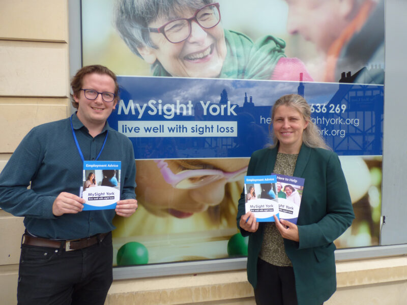 A photo of Rachael Maskell MP and Dom Tooze, an employment adviser outside "My Sight York" with an employment advise booklet.
