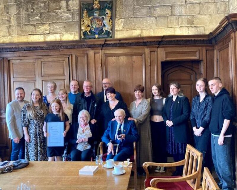 John Avery with Rachael Maskell and surrounded by his family at The Guildhall 